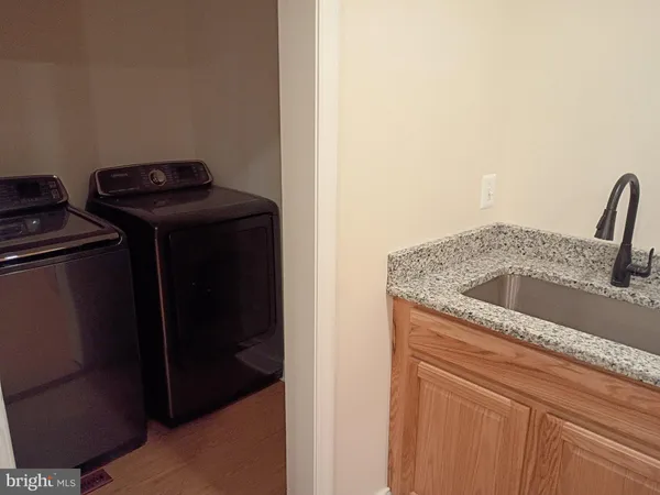 a kitchen with stainless steel appliances granite countertop a sink and a refrigerator
