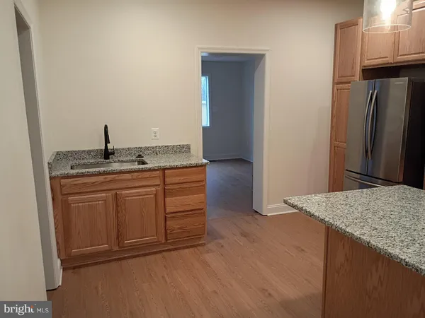 a kitchen with granite countertop stainless steel appliances and refrigerator