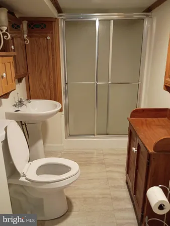 a white toilet sitting next to a bathroom sink