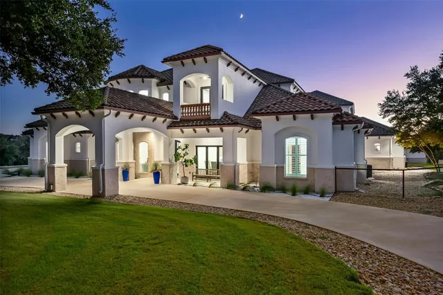 a view of a table and a chandelier in a room