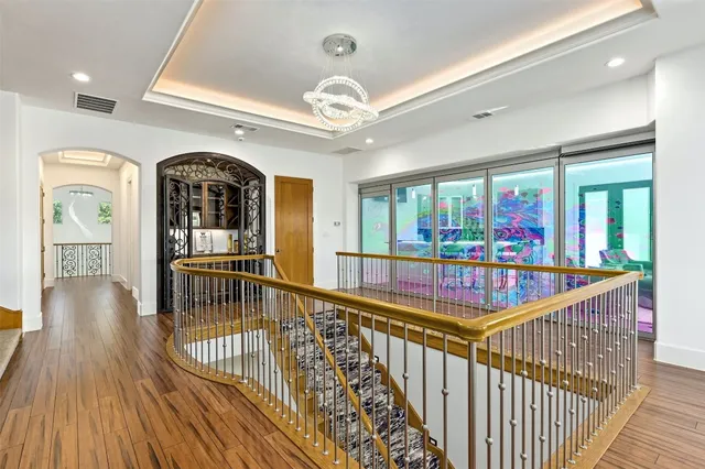 a spacious bedroom with a bed and a wooden floor