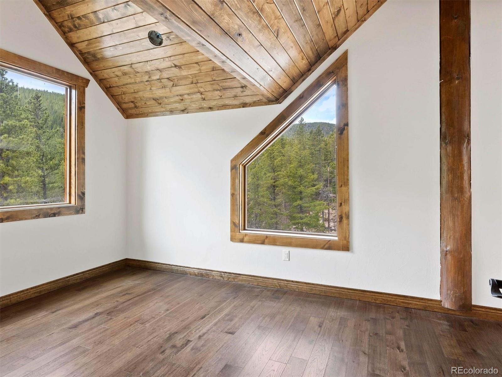 733 Rainbow Road Idaho Springs, CO 80452 - Photo 21 of 47 an empty room with wooden floor and windows