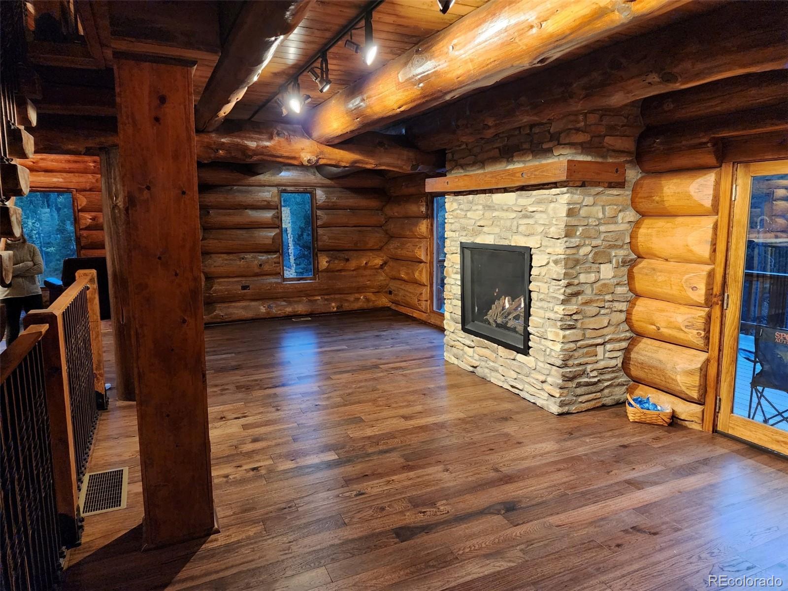 733 Rainbow Road Idaho Springs, CO 80452 - Photo 5 of 47 a view of an empty room with wooden floor and a window