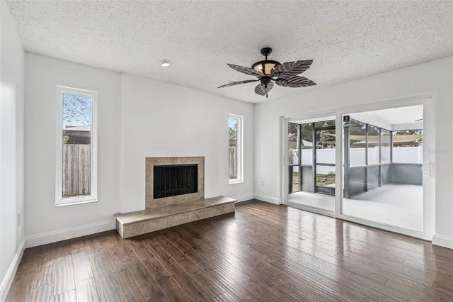a view of a livingroom with wooden floor and a ceiling fan