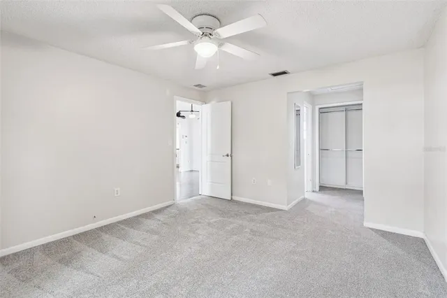 an empty room with fan and a ceiling fan