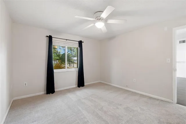 an empty room with windows and closet