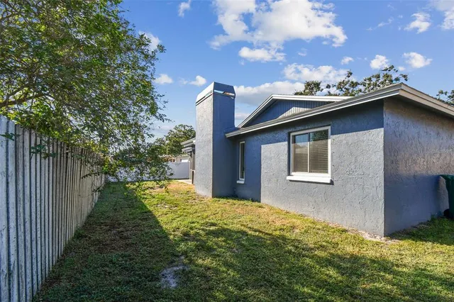a backyard of a house with table and chairs