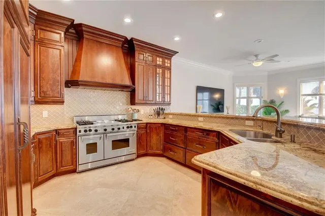 a kitchen with stainless steel appliances granite countertop a stove a sink and a microwave