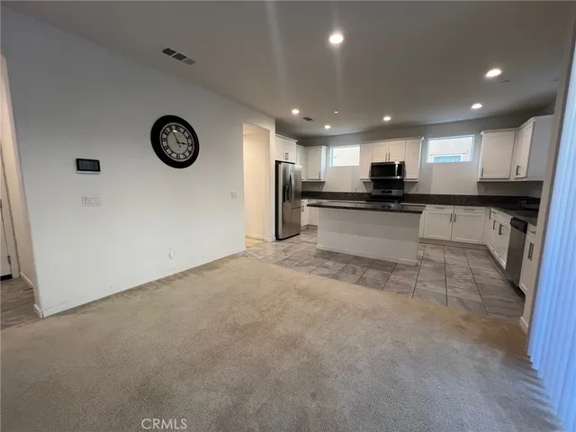 a large kitchen with a large counter top appliances and cabinets
