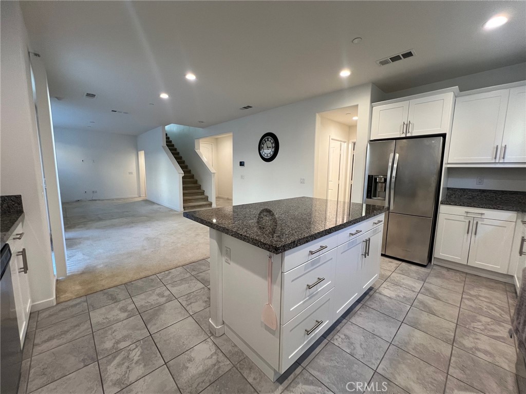 6986 Silverado Street Chino, CA 91710 - Photo 5 of 23 a kitchen with stainless steel appliances granite countertop a refrigerator and a stove