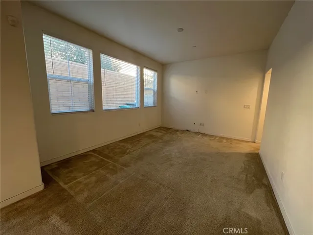 an empty room with a empty space and windows