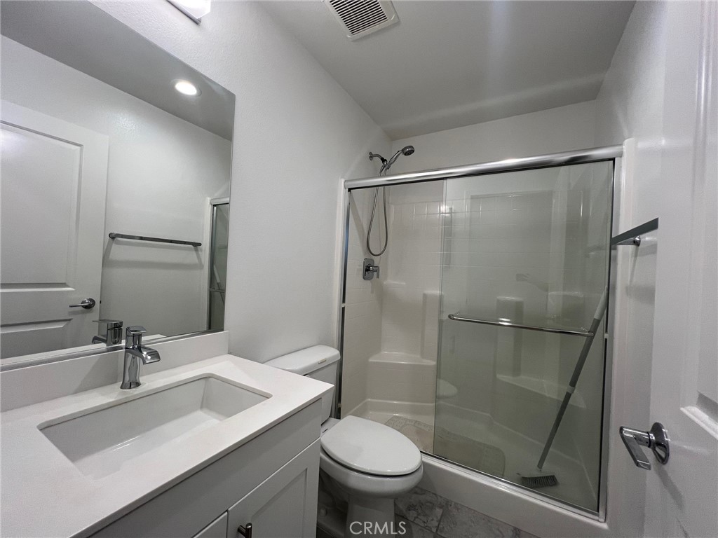 6986 Silverado Street Chino, CA 91710 - Photo 8 of 23 a bathroom with a sink toilet and shower
