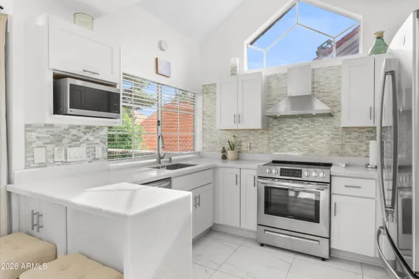 a kitchen with a sink stove and microwave