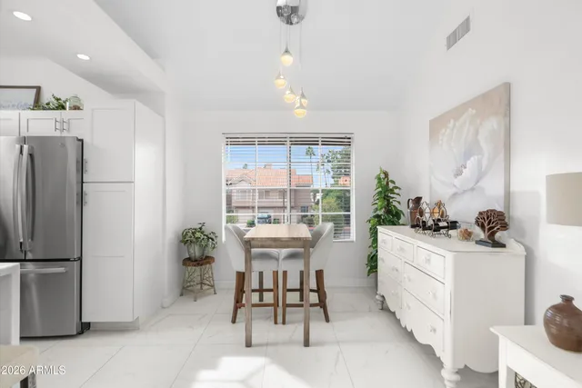 a kitchen with a sink a refrigerator and a stove top oven