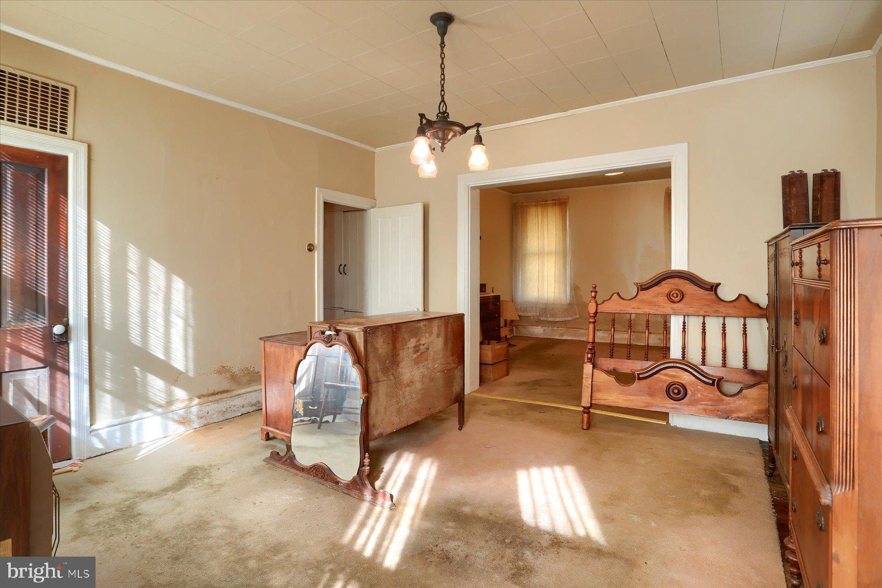 283 North Locust Point Road Mechanicsburg, PA 17050 - Photo 14 of 33 a spacious bedroom with a bed and a chandelier