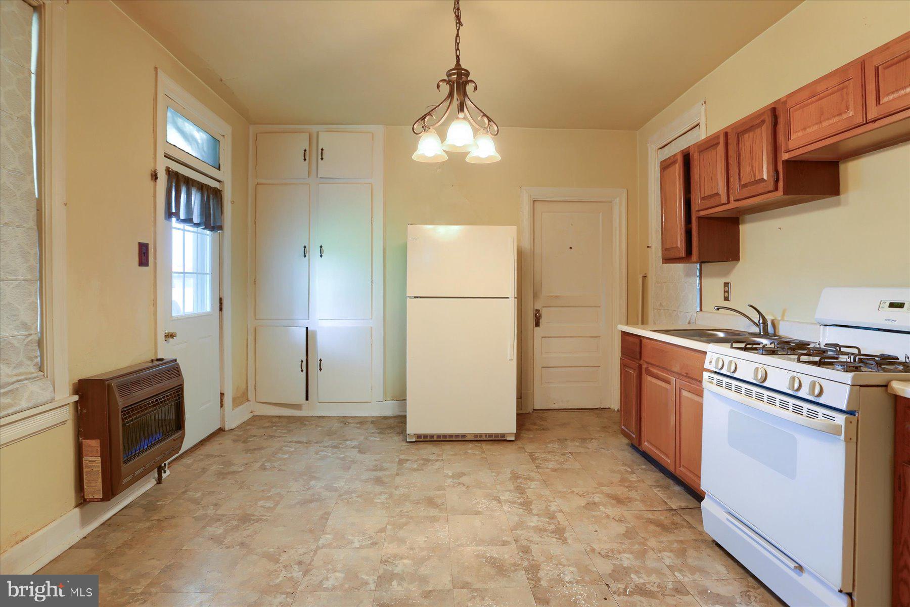 283 North Locust Point Road Mechanicsburg, PA 17050 - Photo 3 of 33 a kitchen with stainless steel appliances granite countertop a refrigerator a stove and a sink with wooden floor