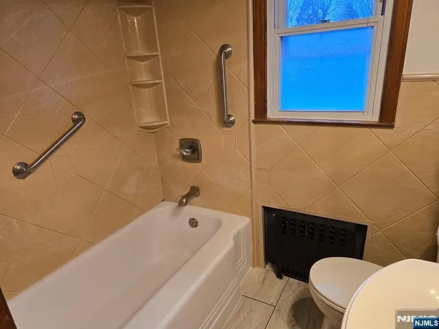 a bathroom with a toilet a sink and bathtub