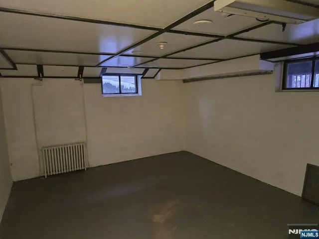 a view of a room with wooden floor and windows