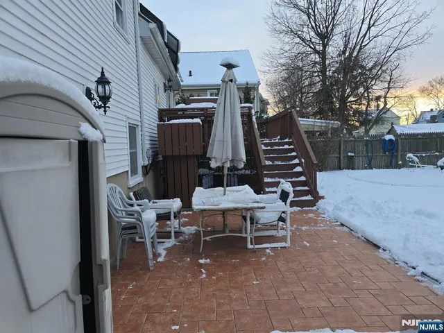 a view of a chairs and tables in the back yard of the house