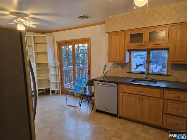a kitchen with sink and cabinets