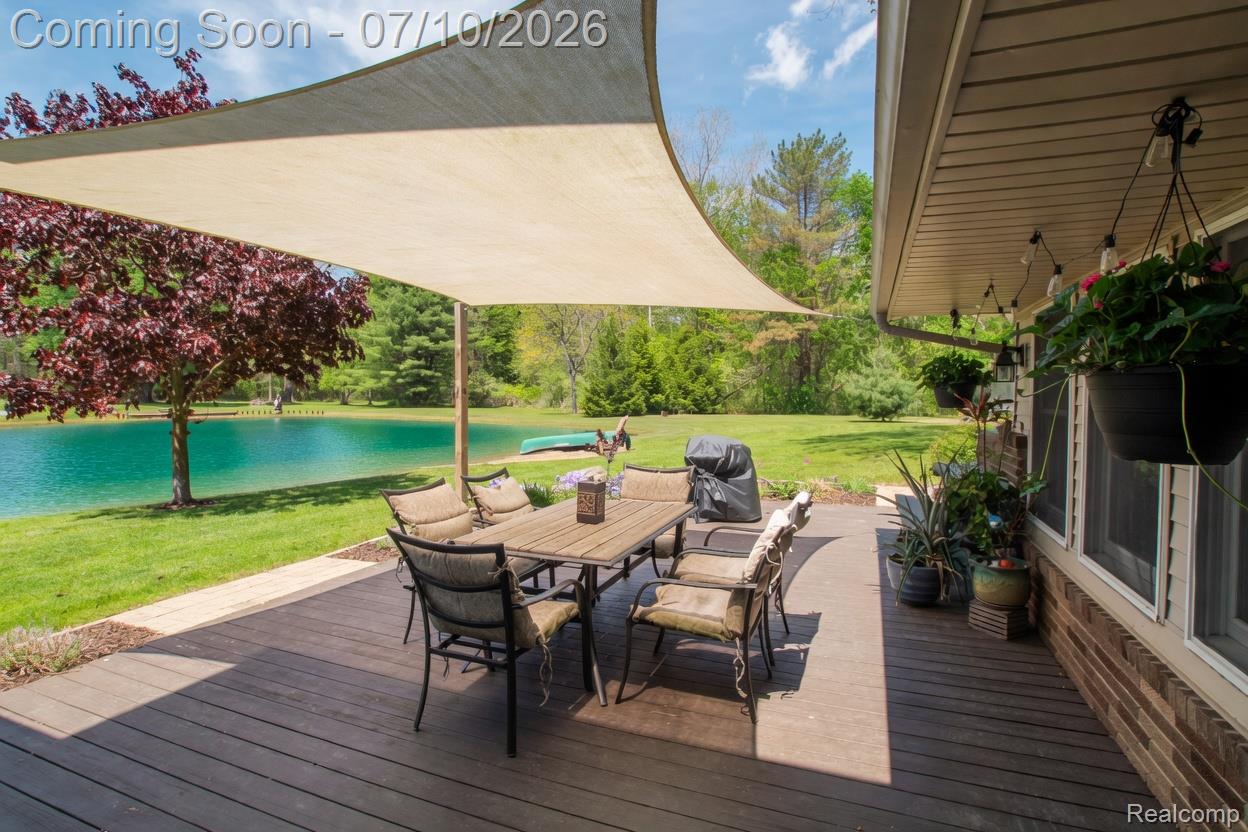 5278 Skelton Road Columbiaville, MI 48421 - Photo 8 of 64 Expansive outdoor deck featuring wood-finish decking and a sail shade canopy