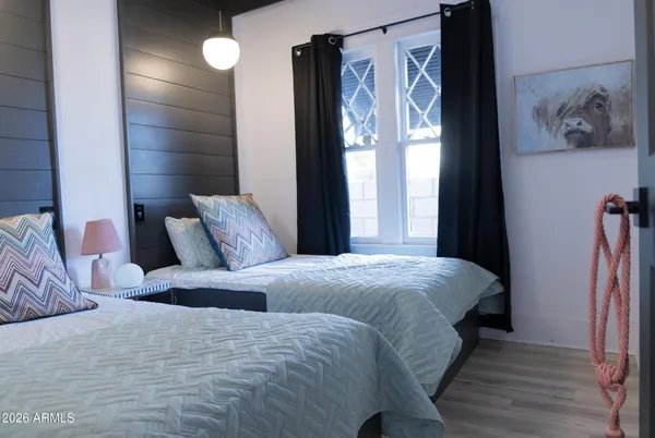 a bedroom with a bed and a painting on the wall