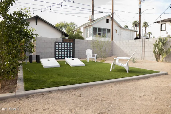 a view of a chair and table in the backyard