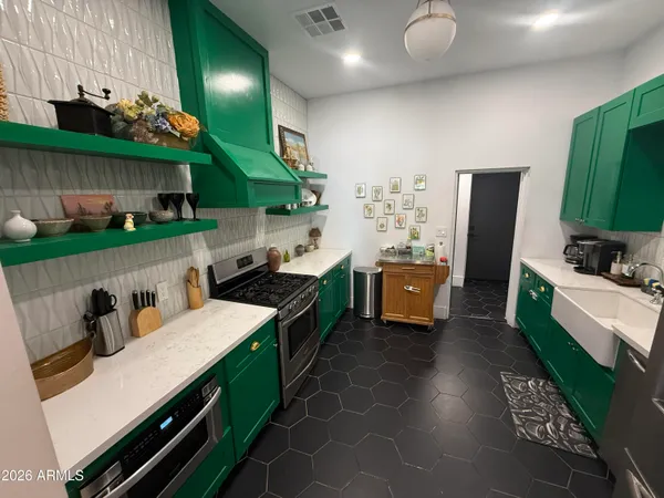 a kitchen with stainless steel appliances kitchen island a stove and a sink