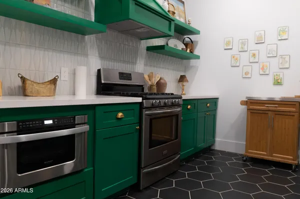 a kitchen with stainless steel appliances a stove and a microwave