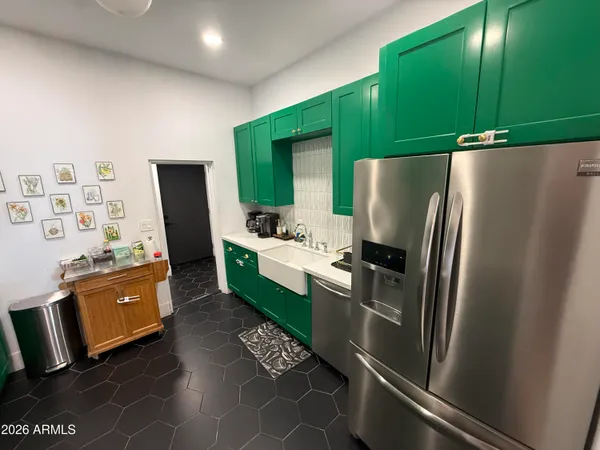 a kitchen with stainless steel appliances a refrigerator and a stove