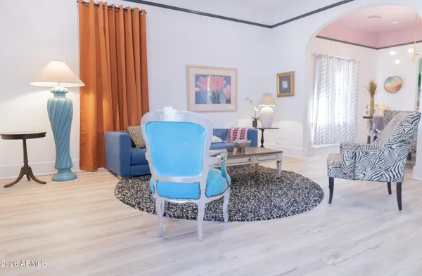 a living room with furniture and a lamp