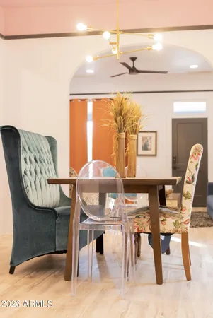 a view of a dining room with furniture and chandelier