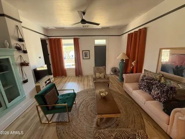 a living room with furniture and wooden floor