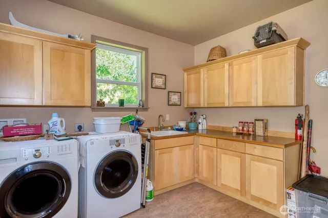 a view of a kitchen with sink washer and dryer