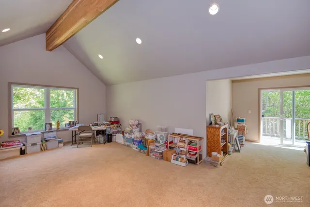 a view of a room with furniture and a large window