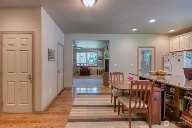 a view of a hallway with dining room and stairs