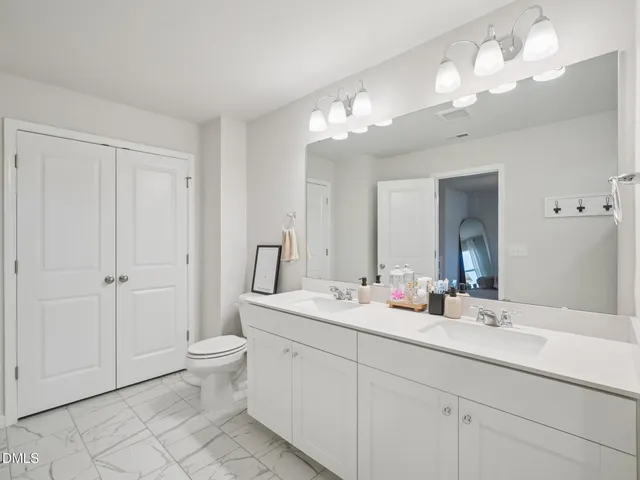 a bathroom with a double vanity sink and a mirror