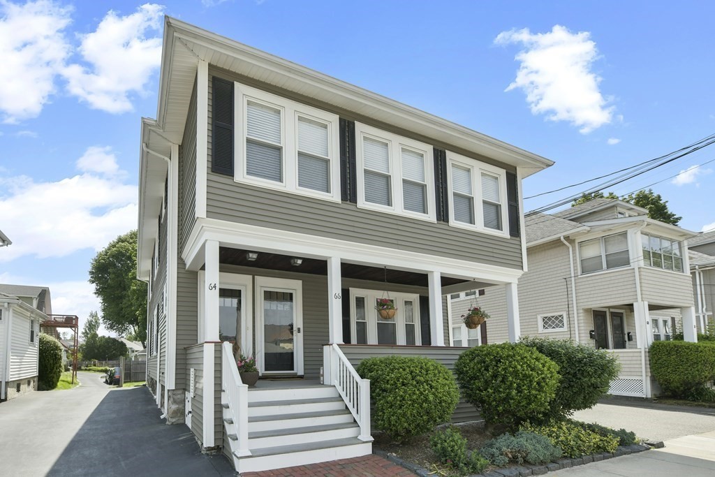 64 Parmenter Road, Unit 1 Waltham, MA 02453 - Photo 1 of 25 a front view of a house with a porch