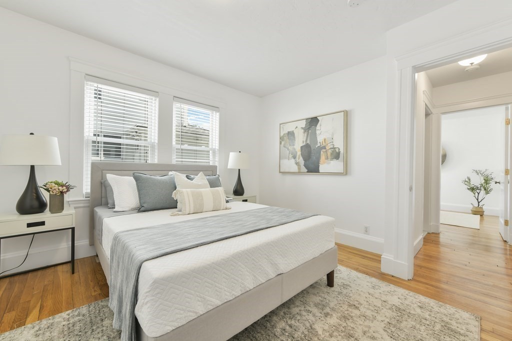 64 Parmenter Road, Unit 1 Waltham, MA 02453 - Photo 15 of 25 a bedroom with a bed and a view of kitchen