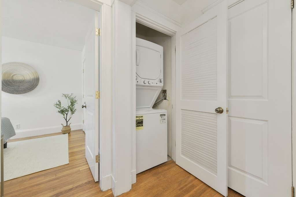 64 Parmenter Road, Unit 1 Waltham, MA 02453 - Photo 17 of 25 a view of a hallway with wooden floor and closet
