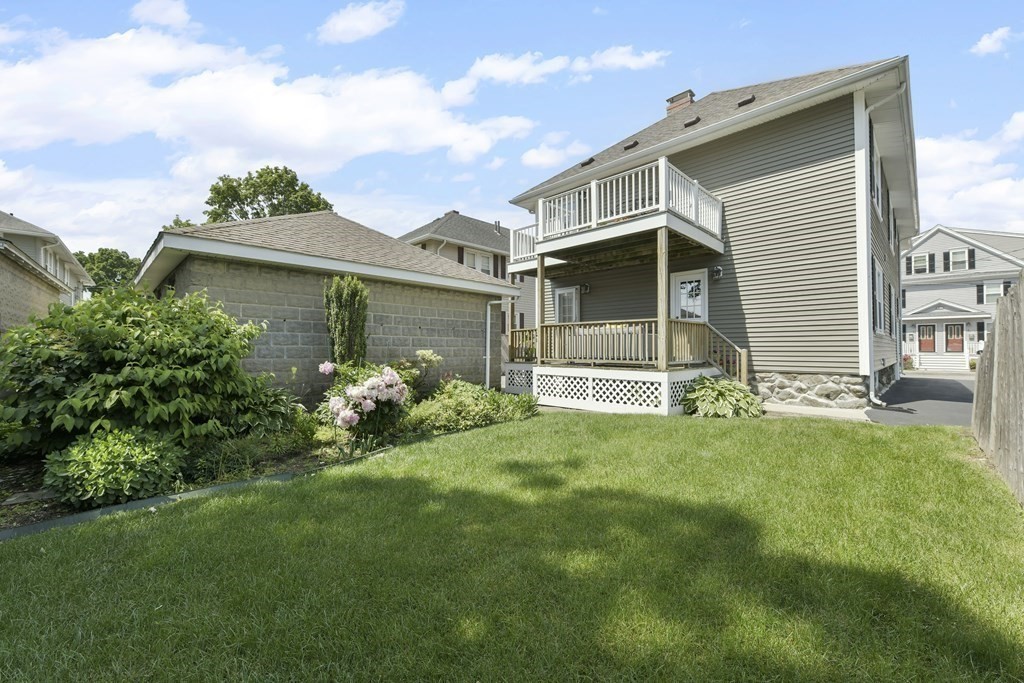 64 Parmenter Road, Unit 1 Waltham, MA 02453 - Photo 20 of 25 a front view of a house with a yard