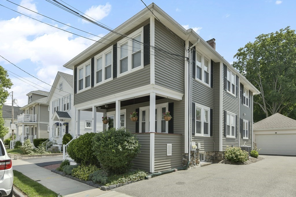 64 Parmenter Road, Unit 1 Waltham, MA 02453 - Photo 24 of 25 a front view of a house with a yard