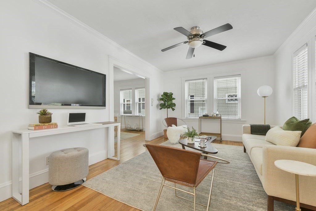 64 Parmenter Road, Unit 1 Waltham, MA 02453 - Photo 4 of 25 a living room with furniture and a flat screen tv