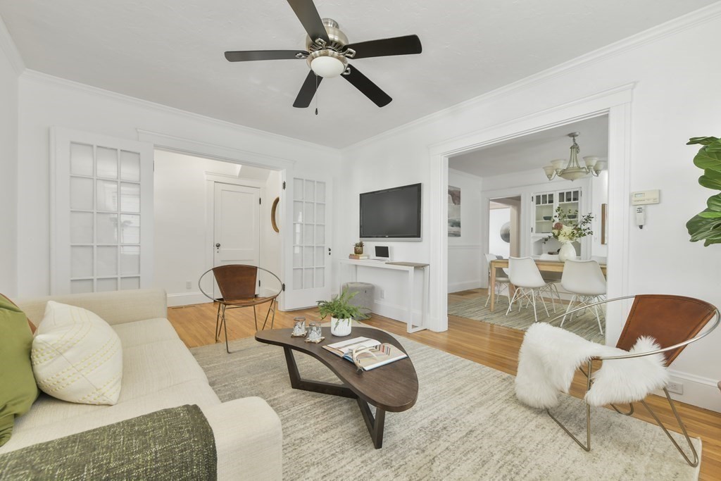 64 Parmenter Road, Unit 1 Waltham, MA 02453 - Photo 5 of 25 a living room with furniture and a flat screen tv