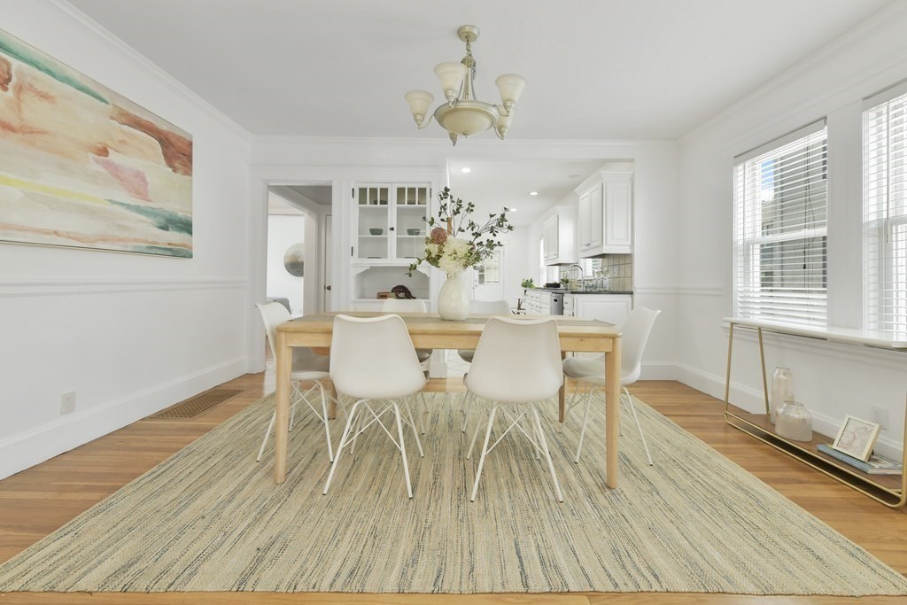 64 Parmenter Road, Unit 1 Waltham, MA 02453 - Photo 7 of 25 a view of a dining room with furniture wooden floor and chandelier