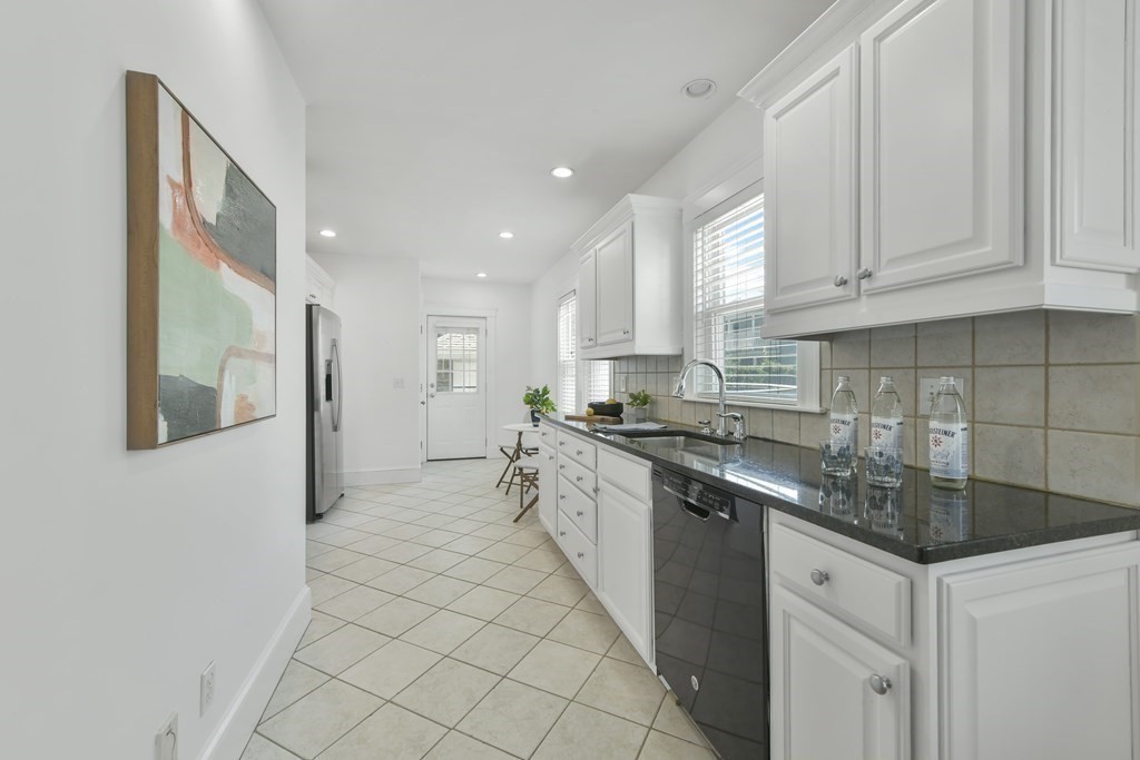 64 Parmenter Road, Unit 1 Waltham, MA 02453 - Photo 10 of 25 a kitchen with stainless steel appliances granite countertop a sink and cabinets