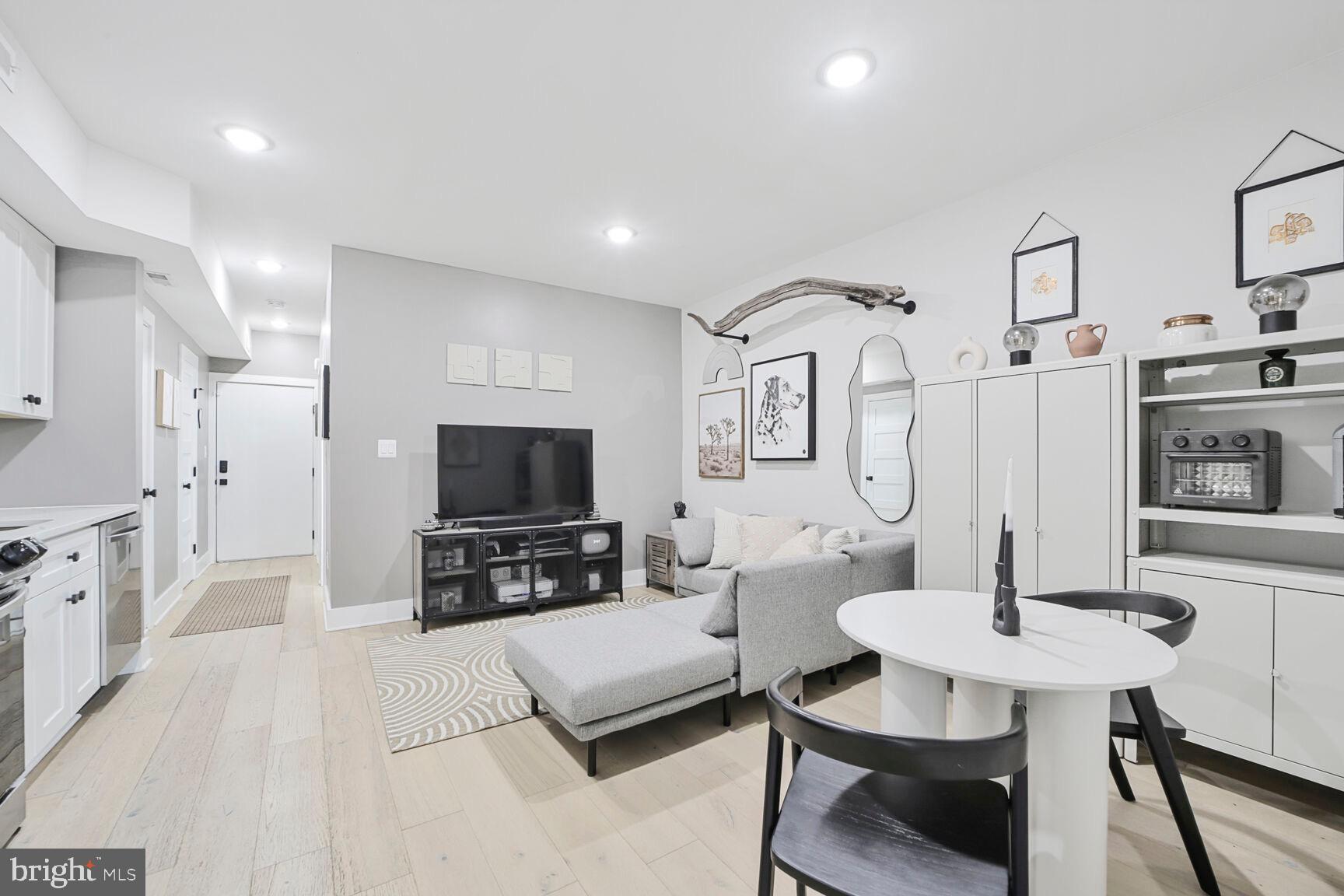 1144 Owen Place Northeast, Unit 1 Washington, DC 20002 - Photo 11 of 27 a living room with furniture and a flat screen tv