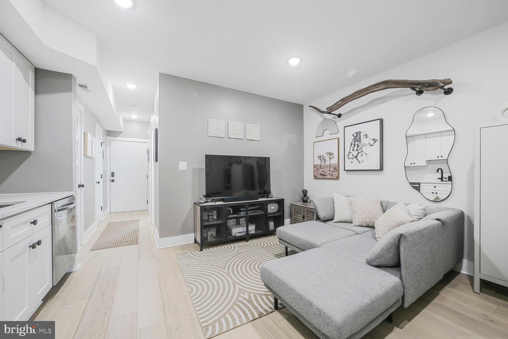 1144 Owen Place Northeast, Unit 1 Washington, DC 20002 - Photo 13 of 27 a living room with furniture and a flat screen tv