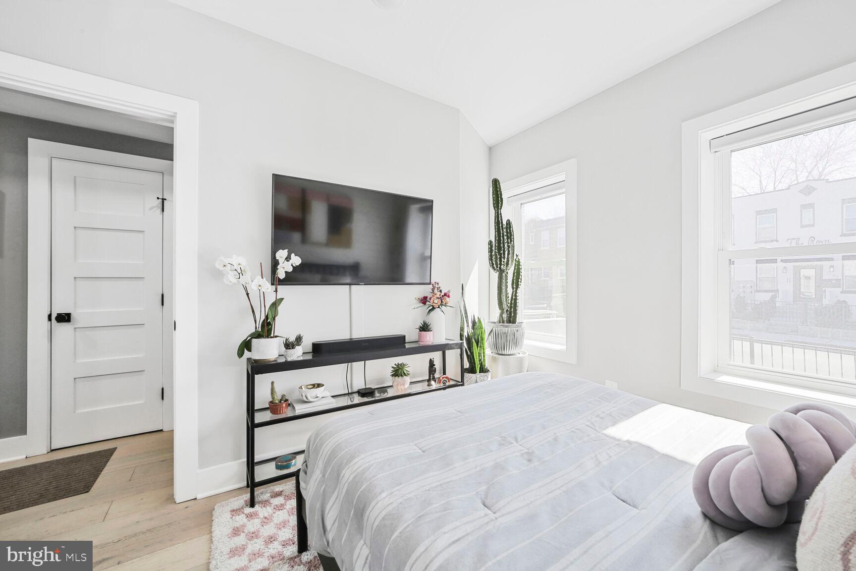 1144 Owen Place Northeast, Unit 1 Washington, DC 20002 - Photo 14 of 27 a bedroom with a bed and a flat screen tv