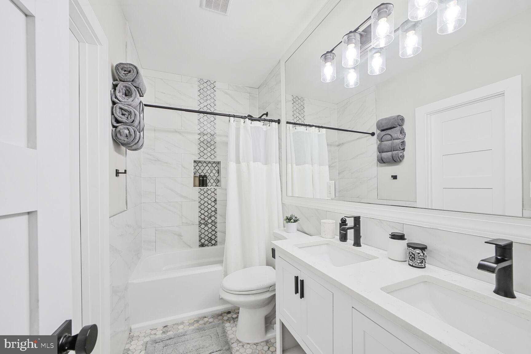 1144 Owen Place Northeast, Unit 1 Washington, DC 20002 - Photo 23 of 27 a bathroom with a sink a toilet and shower